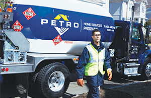 Petro service tech in front of oil truck